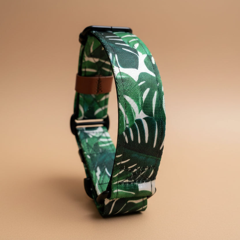 Green leaf-patterned dog collar on a beige background