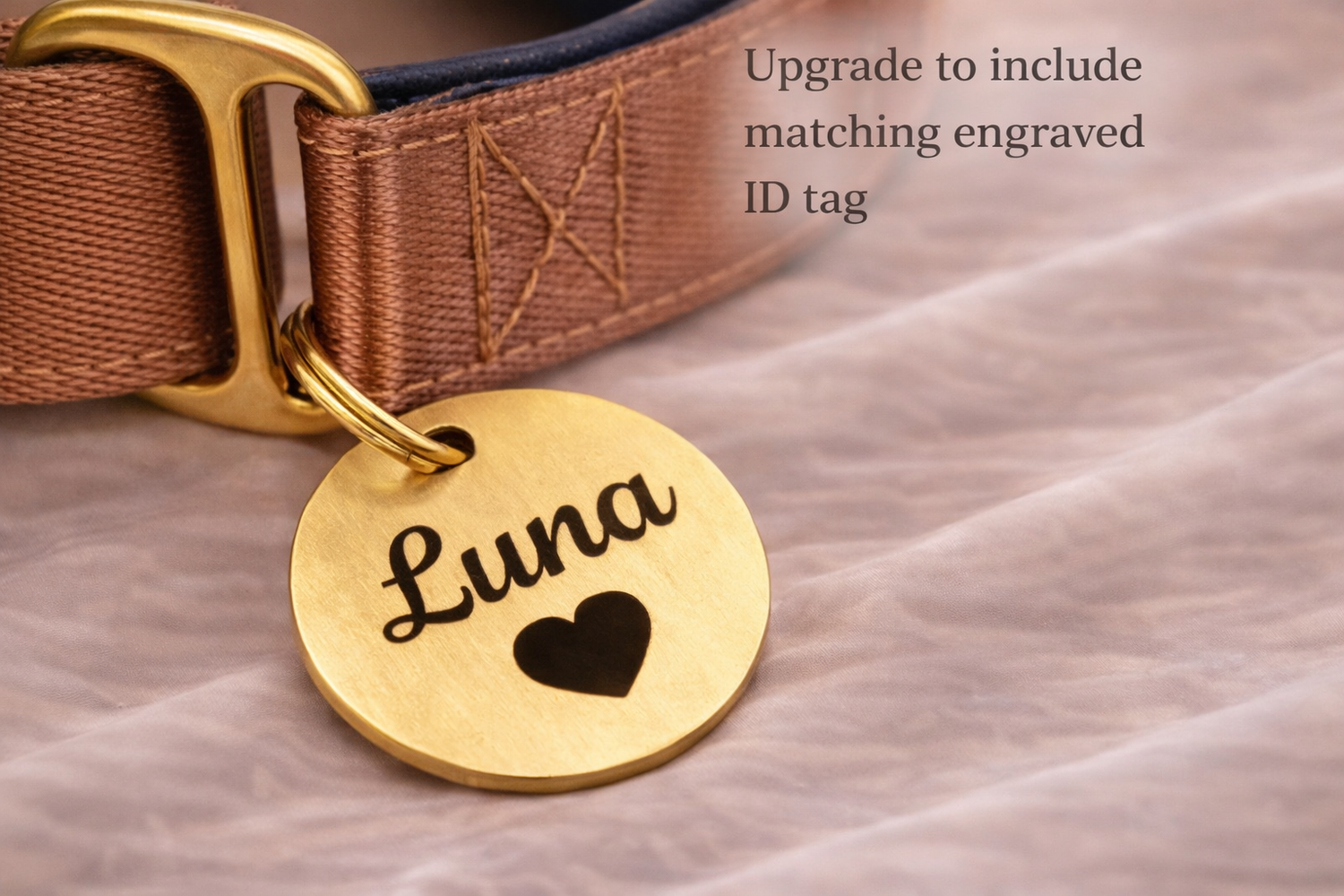 A gold-colored dog collar with a personalized name tag attached, featuring the name "Luna" and a heart symbol.
