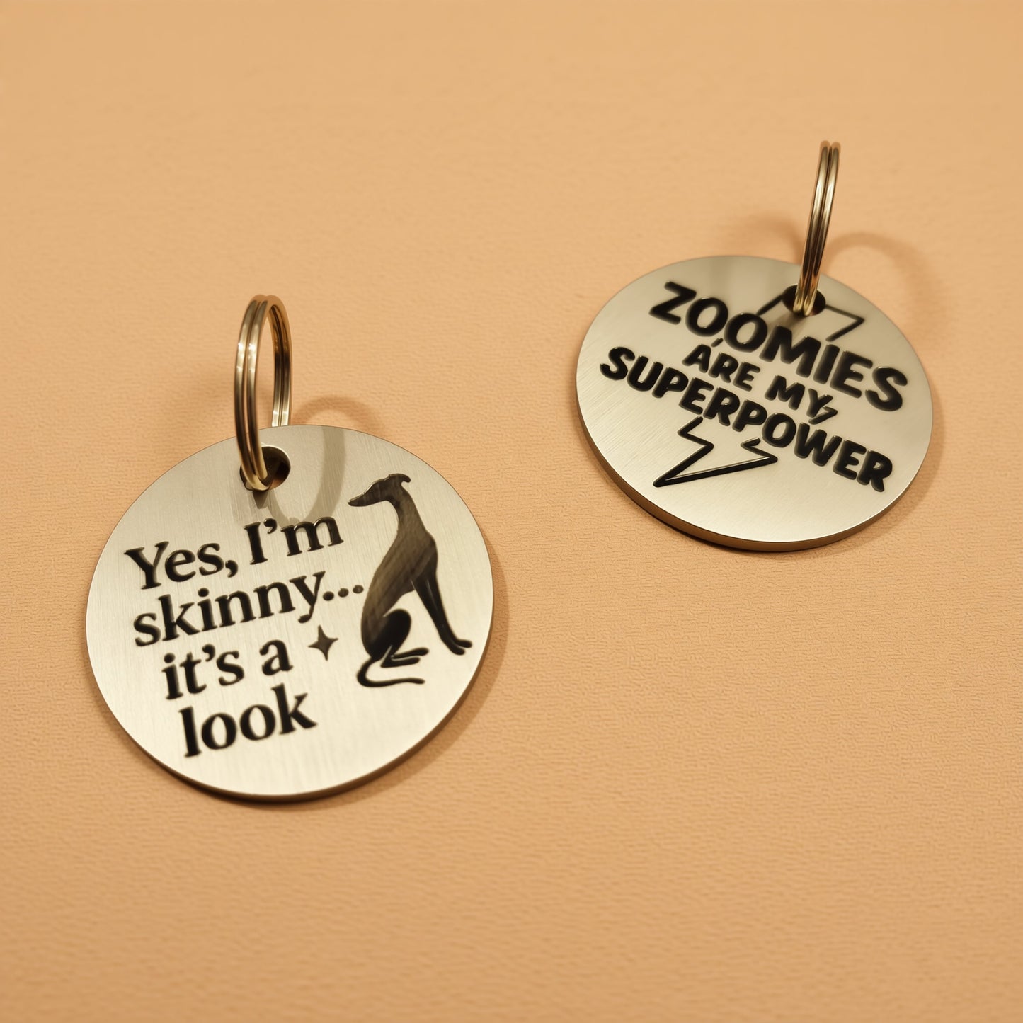 Two round metal tags with humorous text on them.