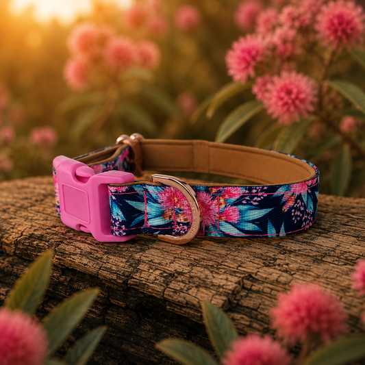 Floral-patterned dog collar with pink buckle on a wooden surface with flowers in the background
