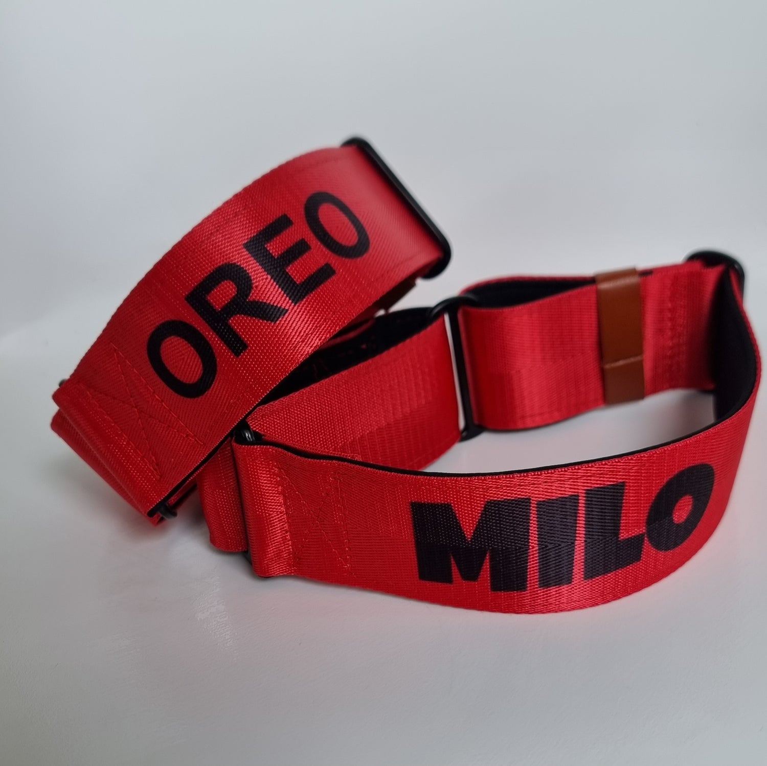 Red dog collars with 'OREO' and 'MILO' printed