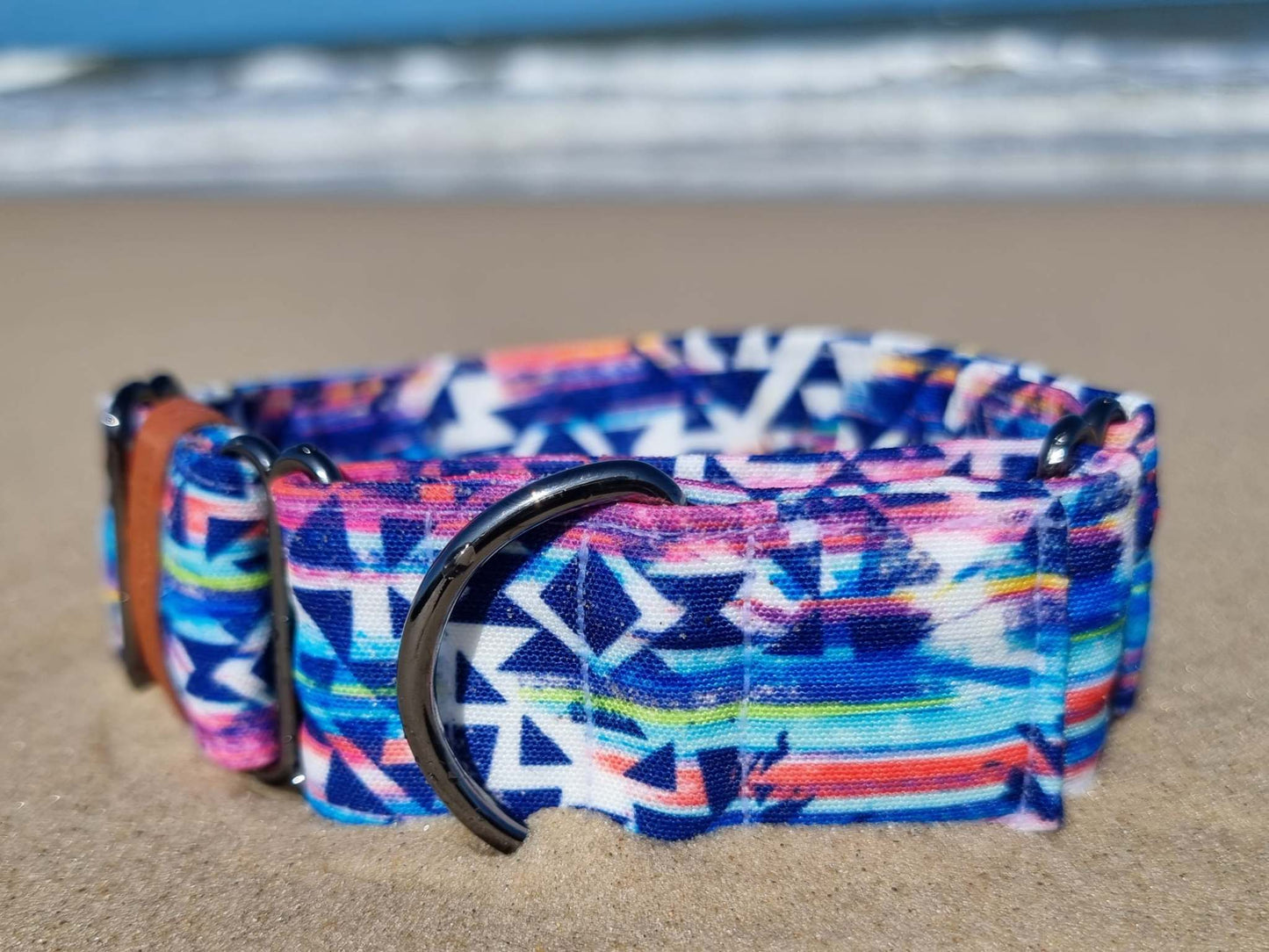 a blue and white bag sitting on top of a beach 